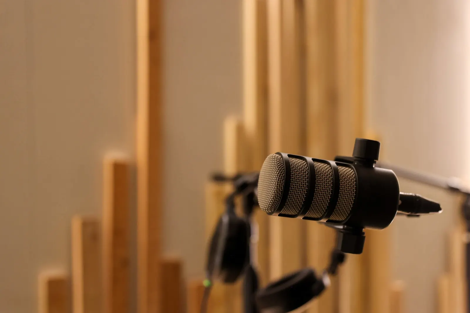 Podcast microphone closeup against wood panels