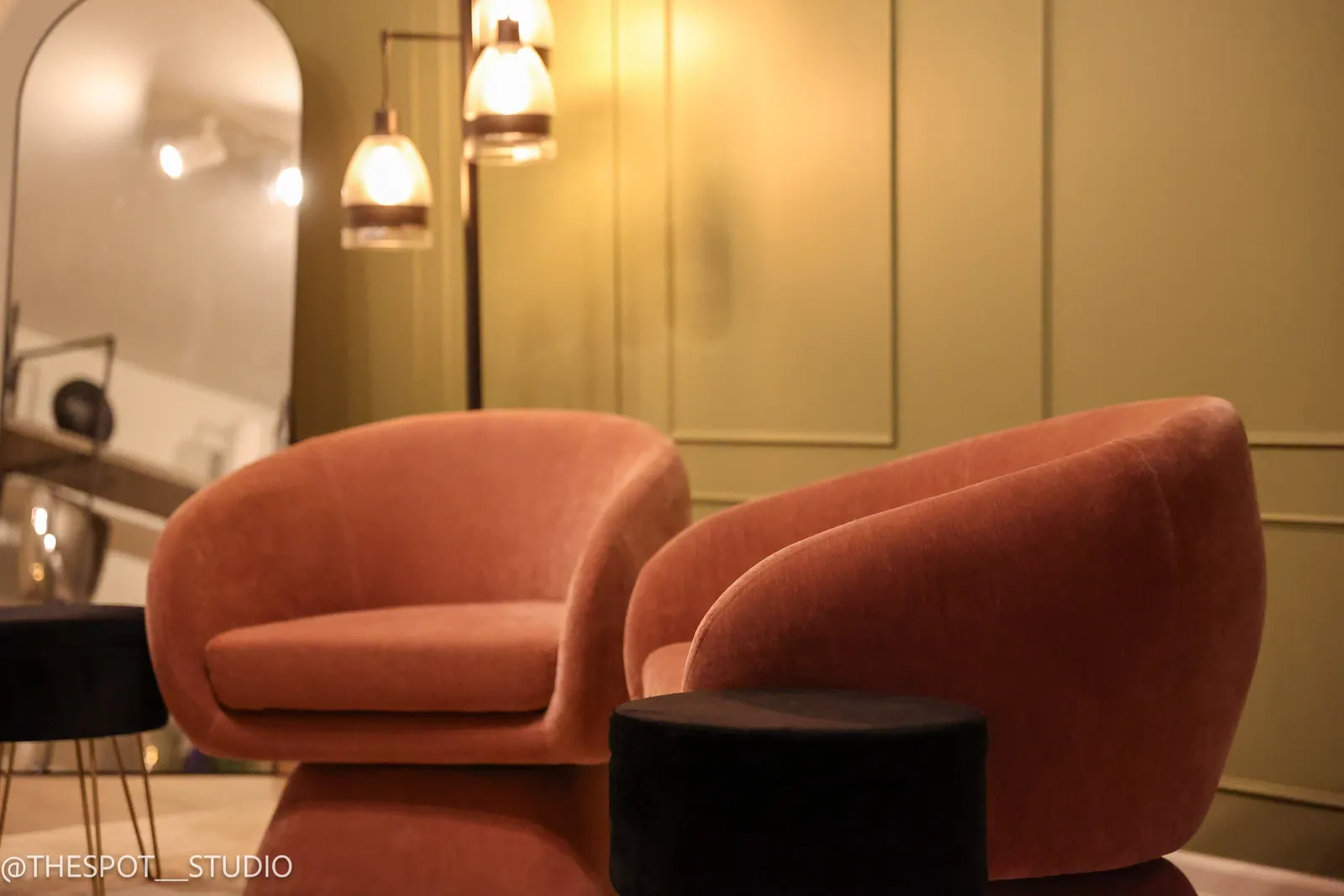 Angled view of the Primary Studio lounge chairs and mirror